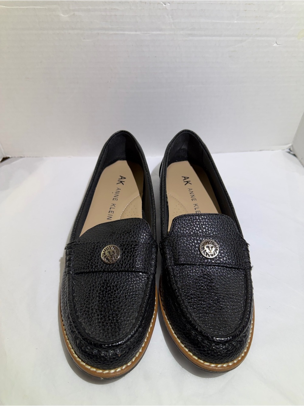 Anne Klein Black Textured Leather Loafers with Gold Emblem